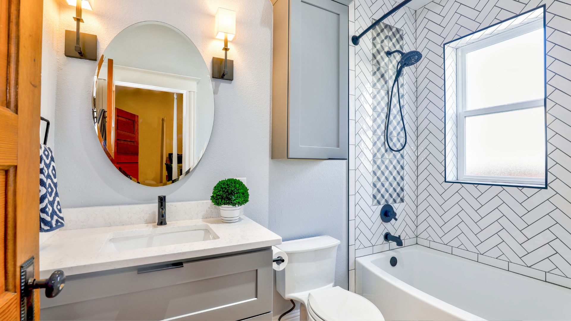 A bathroom with a sink, mirror, toilet and bathtub