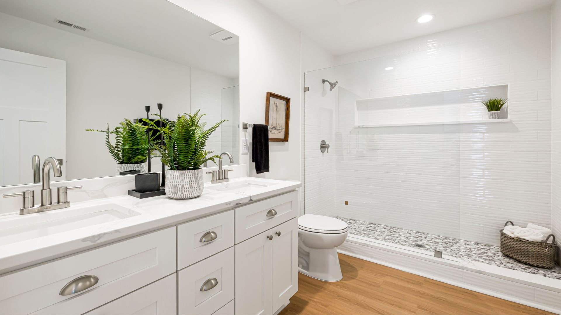 A bathroom with a toilet, sink, and shower