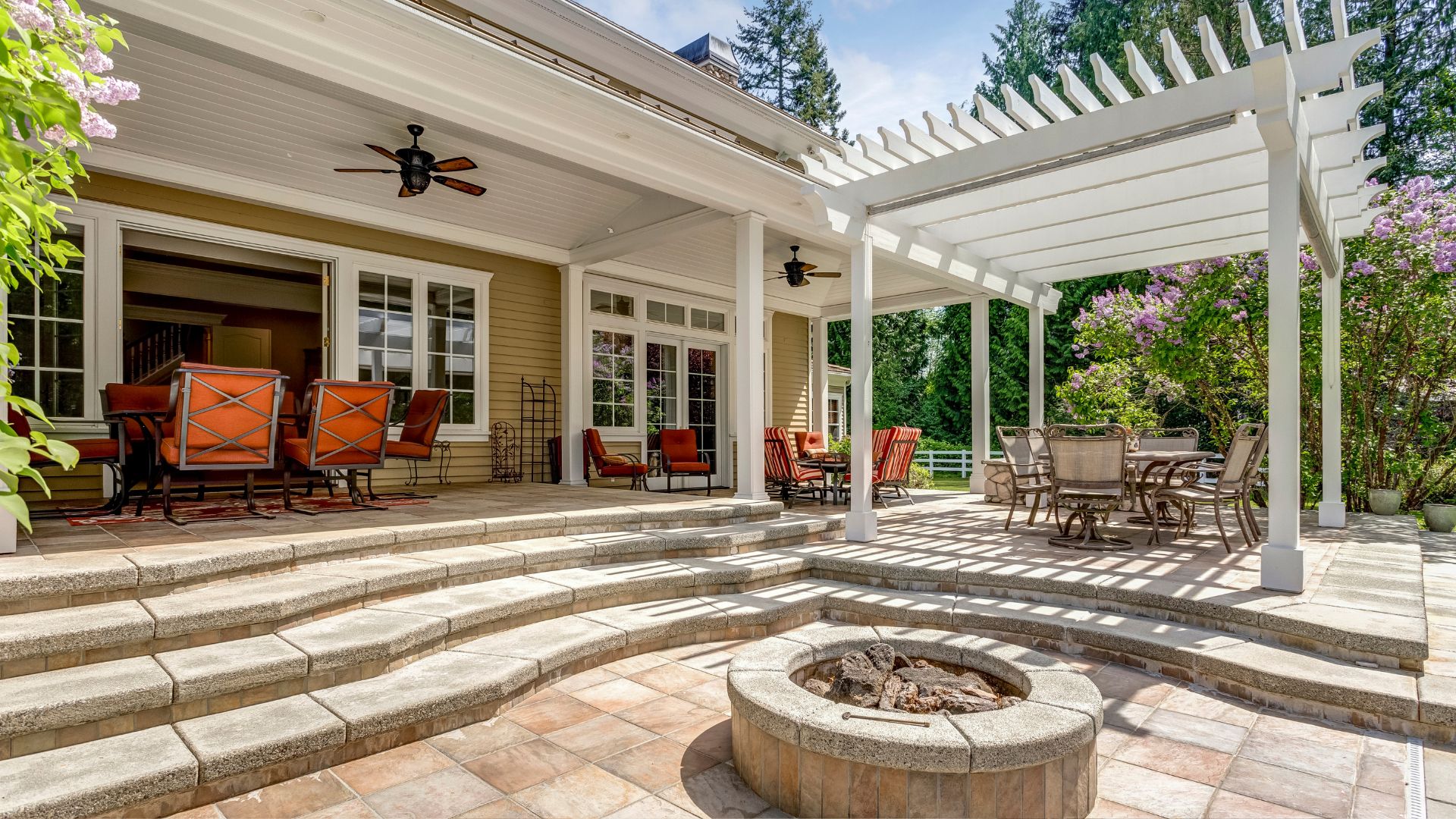 A patio with a fire pit and seating area