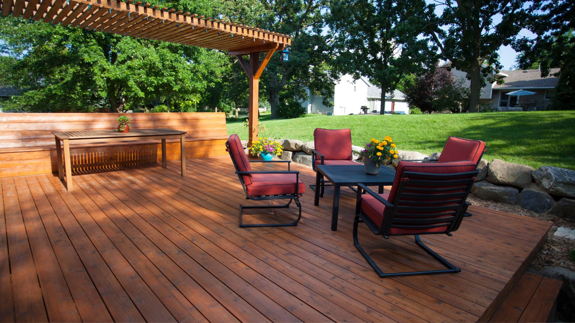 A wooden deck with chairs and a table